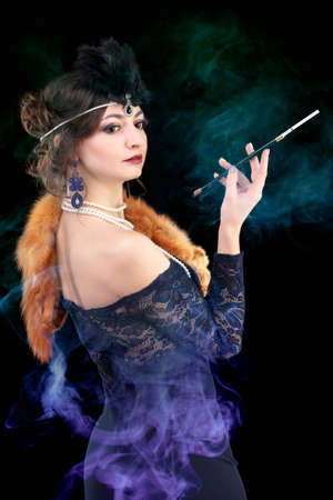 Retro woman portrait. Beautiful woman in the style of 20s or 30s with a mouthpiece in colored smoke.