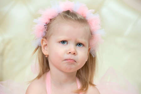 Portrait of a little sad girl. Two-year-old child.