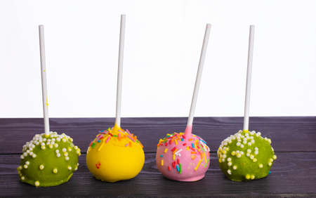 Multicolored candy or cake on a stick on a white background. A beautiful dessert.の写真素材