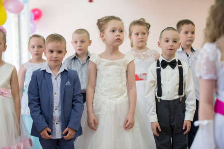 Belarus, the city of Gomil, 26.04.2019 Kindergarten in the city. Beautiful girls and boys of preschool age at the matinee in kindergarten.のeditorial素材