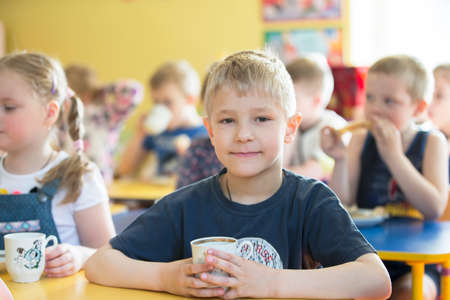 Belarus, the city of Gomil, 26.04.2019 Kindergarten in the city. Preschooler boy holding a cup.のeditorial素材