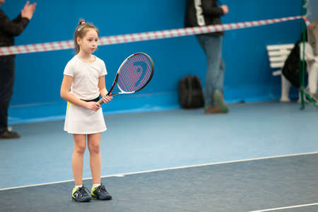 Belarus, the city of Gomil, April 01, 2021. Children's tennis competitions. A girl with a tennis racket on the court.のeditorial素材