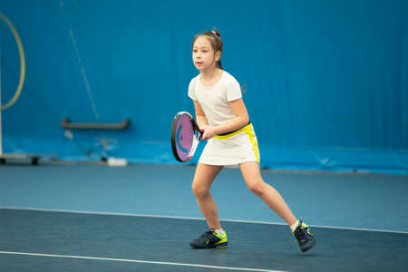 Belarus, the city of Gomil, April 01, 2021. Children's tennis competitions. A girl with a tennis racket on the court.のeditorial素材