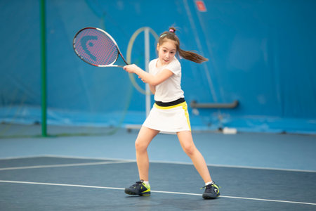 Belarus, the city of Gomil, April 01, 2021. Children's tennis competitions. A girl with a tennis racket on the court.のeditorial素材