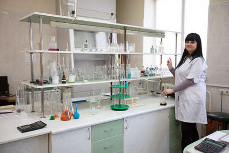 March 19, 2021 Belarus, Gomil. Factory for the production of alcoholic beverages. Laboratory assistant in the laboratory of the alcoholic beverages plant.のeditorial素材
