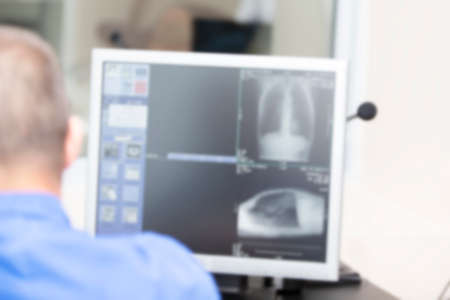 The doctor examines the patient's snapshot on the computer.