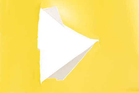 Yellow paper with a cut triangle in the middle.の写真素材