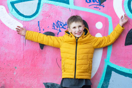 Boy teenager near the wall with graffiti.の写真素材