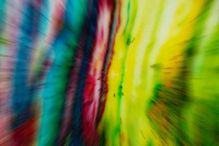 Blurred multicolored colorful background with flying stripes. Bright abstraction.