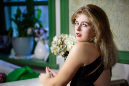 The beautiful blonde girl in the cafe looked back.の写真素材