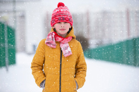 Happy little boy in bright clothes walks on a winter day. child in winter.の写真素材