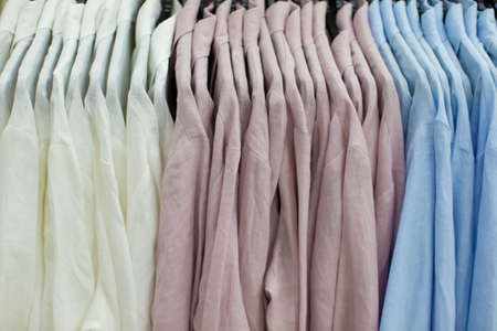 Clothes made of linen hang on hangers in the store.の写真素材