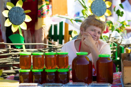 Belarus, Avtyuki village, July 31, 2021. Festival of culture. A woman sells honey.のeditorial素材