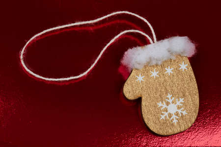 Vintage wooden toy mittens on a dark red background.の写真素材