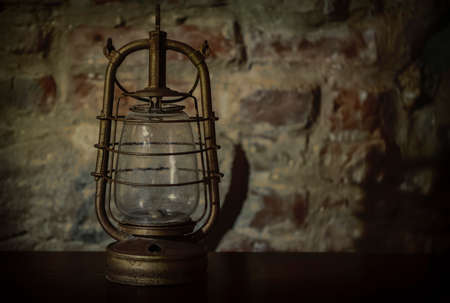 Kerosene lamp on an old vintage background.