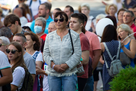 Belarus, Gomil, July 16, 2020. Crowded city street. An elderly woman stands in a crowd of people.