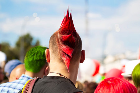 Belarus, Gomil, August 16, 2020. Crowded city streets. A young man with a punk hairstyle stands with his back to the camera.のeditorial素材