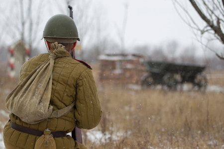 Belarus, Gomil, October 25, 2018 Reconstruction of hostilities. A World War II soldier stands with his back to the camera.のeditorial素材
