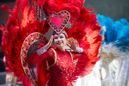 Beautiful girl in red feathers at the Brazilian carnival.のeditorial素材