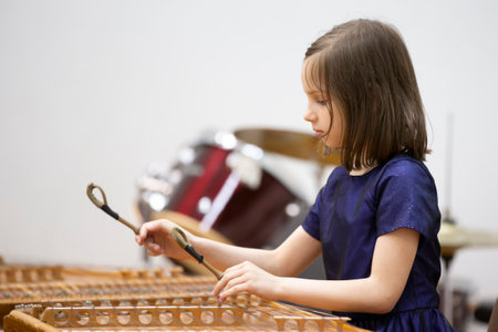 May 21, 2021 city of Gomil. Holiday at the music school. The girl plays the ethnic instrument dulcimerのeditorial素材