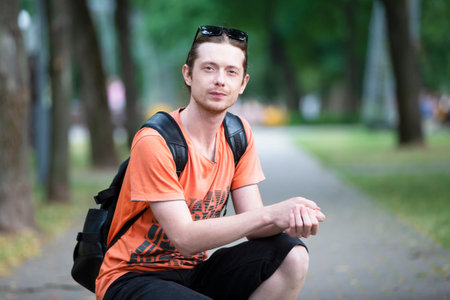 June 23, 2019 gomil city. city street. A man in casual clothes with a backpack looks at the camera.のeditorial素材