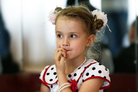 Little girl bites her nails.のeditorial素材