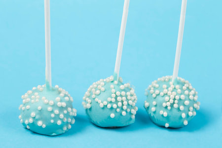 Candies on sticks. Blue cakes on a blue background.Beautiful sweet dessertの写真素材