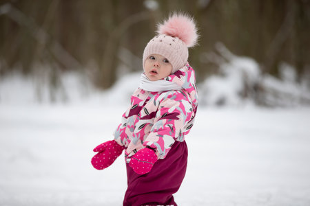Little girl in winter clothes on the background of winter nature. child in winter.の写真素材