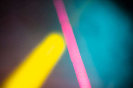 Pink and yellow stage beams on a purple gradient. stage light.