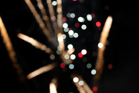 On a black background bokeh from explosions of colorful fireworks.の写真素材