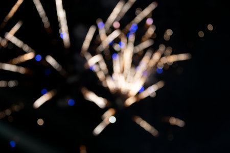 On a black background bokeh from explosions of colorful fireworks.