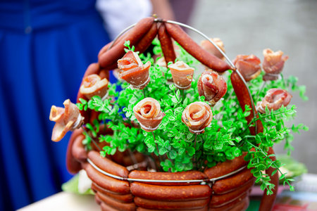 A festive basket of meat products beautifully decorated with greenery.の写真素材