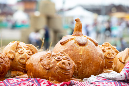 Rural autumn fair. Halloween pastries. Buns in the form of a pumpkin and pigs.の写真素材