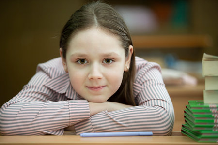 The schoolgirl was tired and put her head on the desk.の写真素材