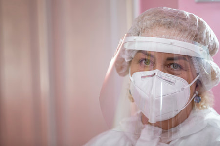 The face of a female doctor close-up in a protective suit.の写真素材