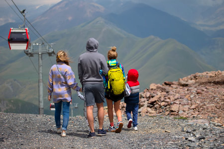 A group of people, a family travels in a mountainous area, rides a cable car.の写真素材