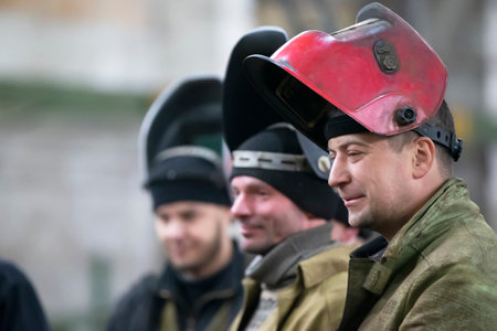 April 19, 2022. Belarus, city of Gomil, Central Metallurgical Plant. Workers in industrial plants. A team of men of a metallurgical plant in overalls.のeditorial素材