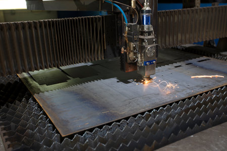 Cutting of metal. Sparks fly from laser.Laser cutting machine working with sheet metal with sparks...