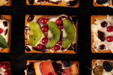 Beautiful square appetizer cakes with a variety of berry fillings. A beautiful sweet dessert.の写真素材