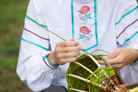 Hands of the master make products from birch bark. Weaving a basket. Ethnic Slavic crafts.の写真素材