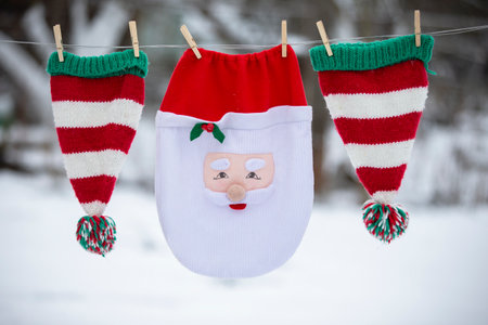 Santa's Christmas bag and striped hats are dried on a rope. Preparing to celebrate Christmas.