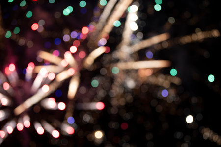 On a black background bokeh from explosions of colorful fireworks.の写真素材
