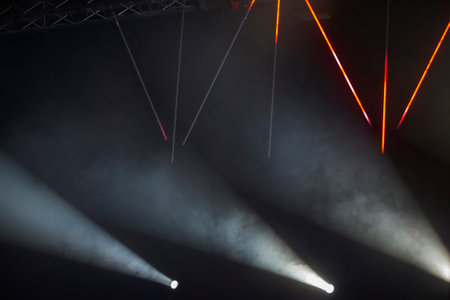 Rays of stage light on a dark background.