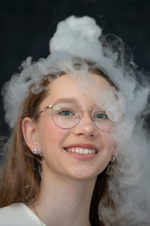 The child is a participant in scientific experiments. Girl in liquid nitrogen smoke.の写真素材