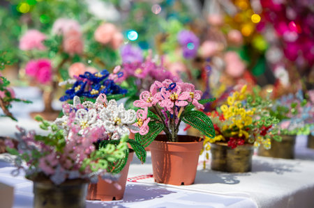 Handicrafts made of beads are sold at the fair. Unique handmade trees from colorful beads.の写真素材