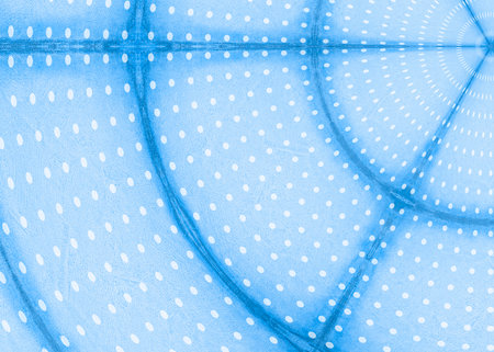Blue paper background with white polka dots with dark blue semicircular stripes.