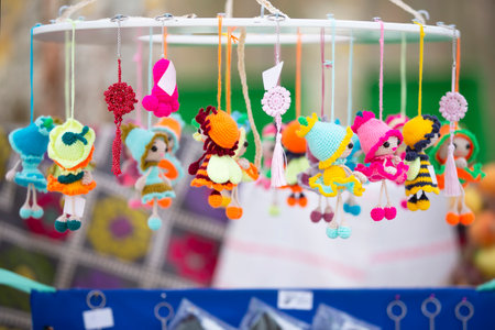 The handicraft fair sells colorful knitted toys and small dolls.の写真素材