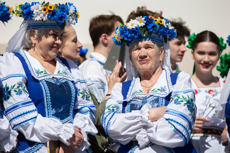 April 28, 2022. Belarus. Gomil region. Holiday of Slavic cultures. A group of elderly Belarusian women in ethnic costumes. Slavic women in national dress.のeditorial素材