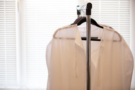Medical white coats hanging on a hangerの写真素材
