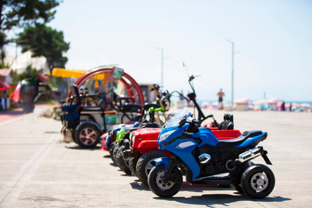 August 6, 2022. Georgia. Ureki village. Central beach with magnetic black sand. Rental electric scooters on the coastline of the beach.の写真素材